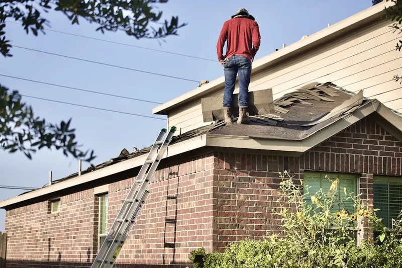 Professional roofer working on a residential roof in Horsham